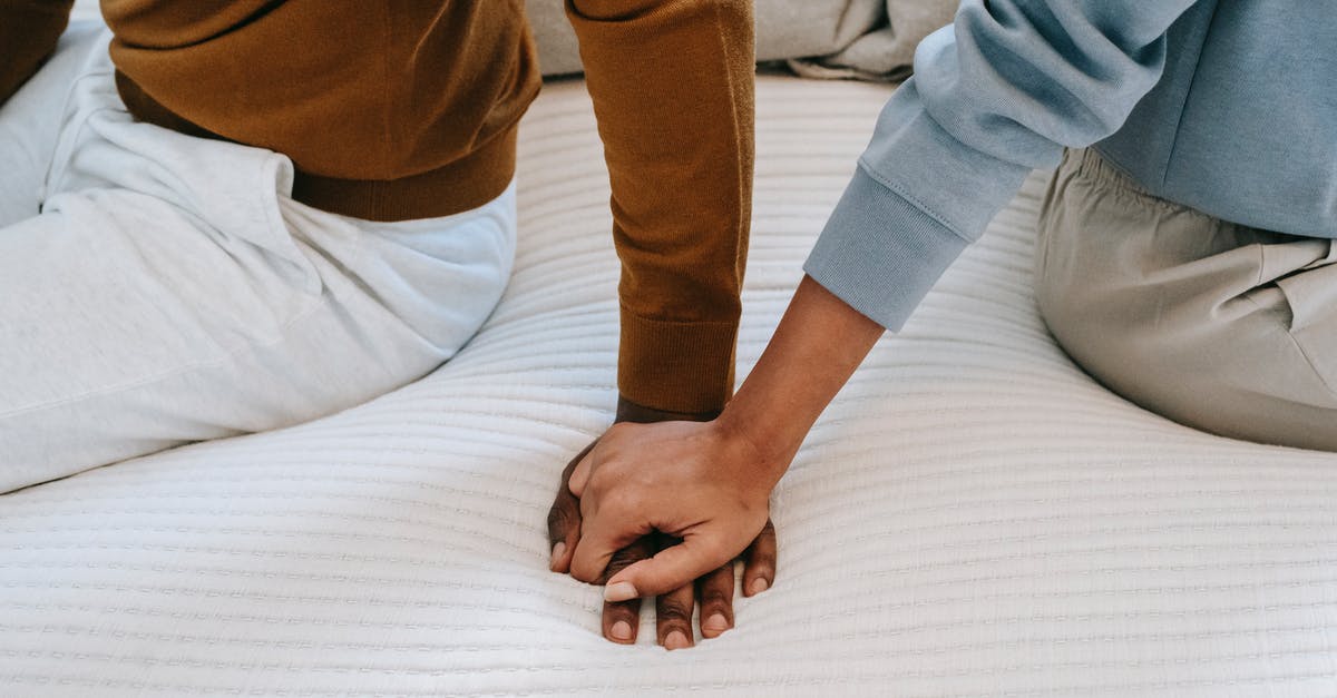 Why does the roux separate from my gumbo? - Crop unrecognizable black couple holding hands on bed