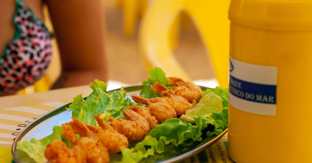Why does the shrimp stick to the shells? - Faceless woman in swimwear eating shrimp tempura on long thin wooden stick on light green leaf of lettuce in outdoor cafe in summertime Why does the shrimp stick to the shells? - Faceless woman in swimwear eating shrimp tempura on long thin wooden stick on light green leaf of lettuce in outdoor cafe in summertime