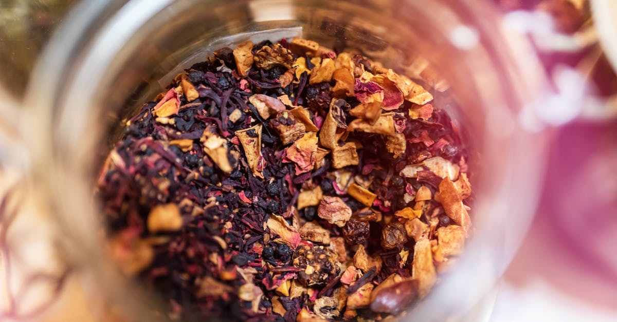 Why does this homemade herbal tea always boil over? - From above of glass jar with dry aromatic fruit tea against blurred background in daylight Why does this homemade herbal tea always boil over? - From above of glass jar with dry aromatic fruit tea against blurred background in daylight