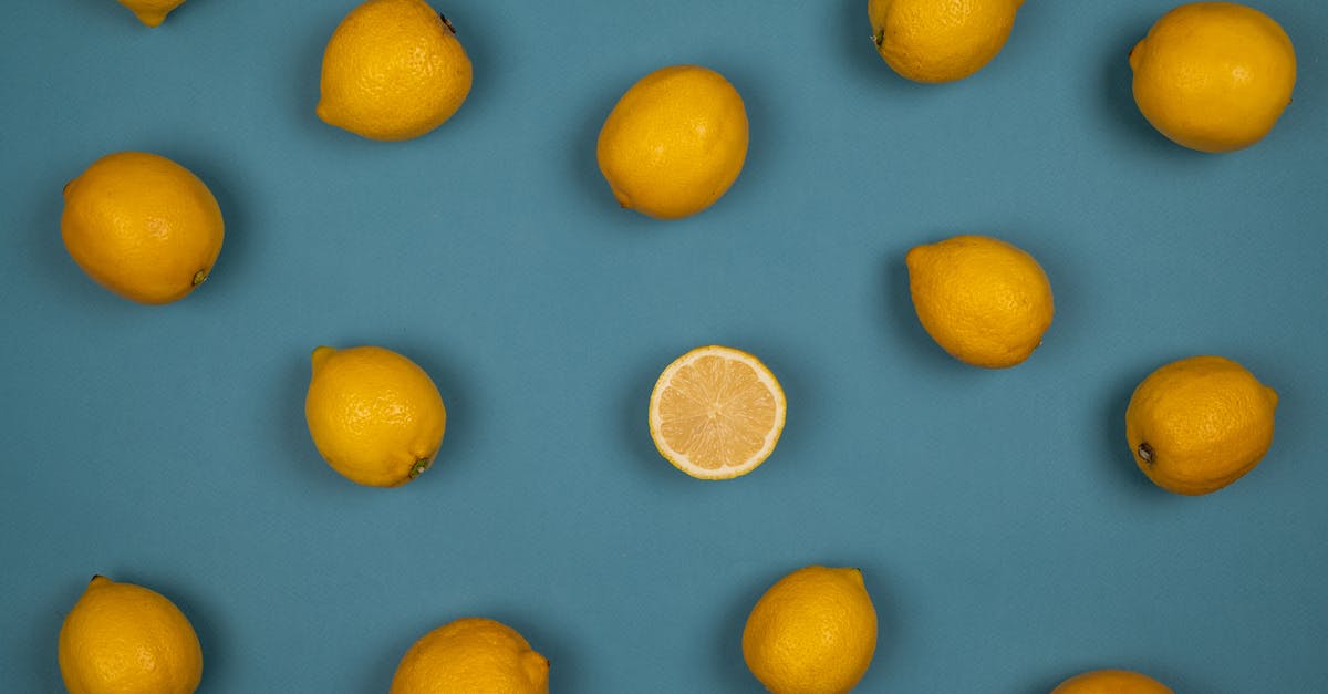 Why does unpeeled fruit rot? - Fresh lemons with juicy flesh on blue background Why does unpeeled fruit rot? - Fresh lemons with juicy flesh on blue background