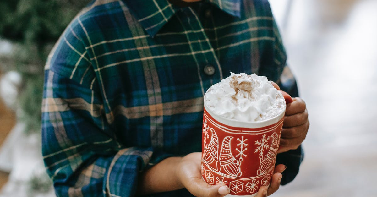Why does whipped Cream sometimes sink in warm beverages? - Black child holding mug of hot drink with foam Why does whipped Cream sometimes sink in warm beverages? - Black child holding mug of hot drink with foam