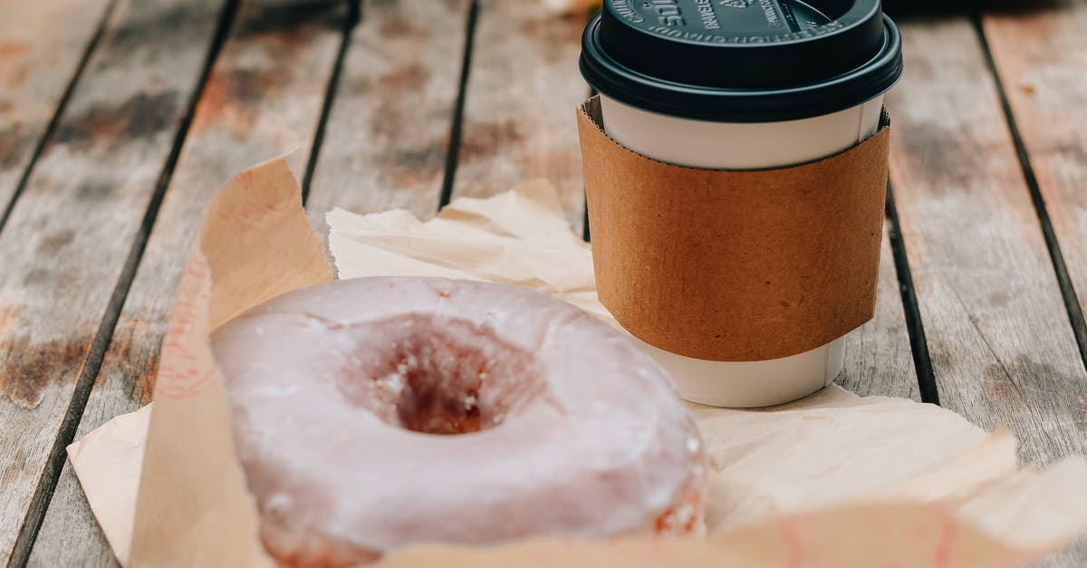 Why doesn't chocolate go bad? - Tasty sweet chocolate donut and takeaway cup of coffee placed on wooden surface in daytime Why doesn't chocolate go bad? - Tasty sweet chocolate donut and takeaway cup of coffee placed on wooden surface in daytime