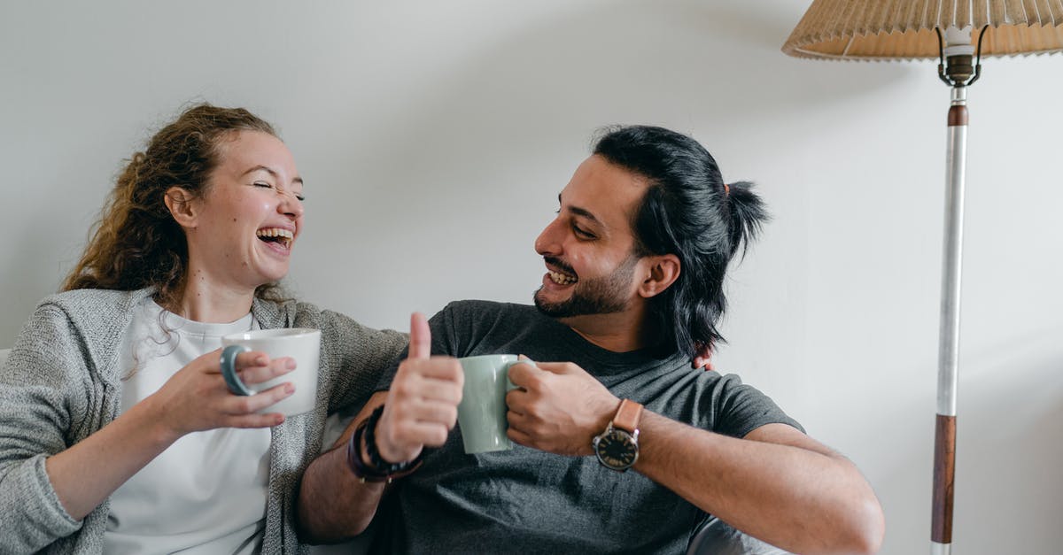 Why don't other grain proteins behave like gluten? - Positive girlfriend in casual wear looking at content ethnic man in smart watch while sitting on cozy sofa with cups of hot beverage and looking at each other Why don't other grain proteins behave like gluten? - Positive girlfriend in casual wear looking at content ethnic man in smart watch while sitting on cozy sofa with cups of hot beverage and looking at each other
