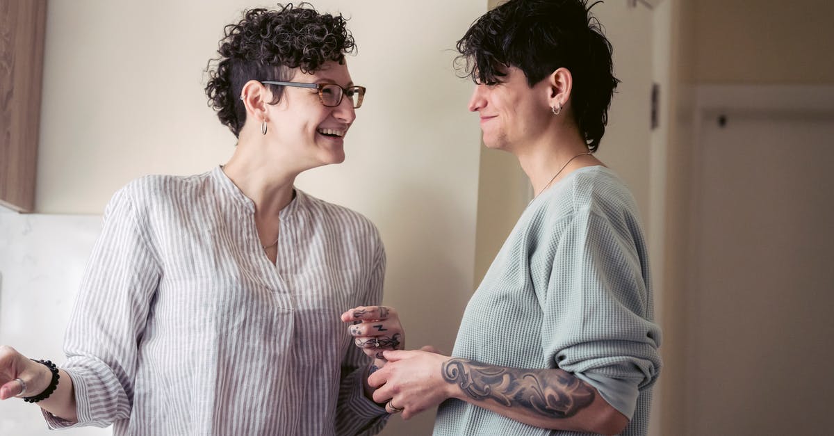 Why don't we all eat injera? Or some other form(s) of teff? [closed] - Cheerful young tattooed female friends with short dark hair in casual clothes laughing and looking at each other while standing in kitchen and eating fresh cherries