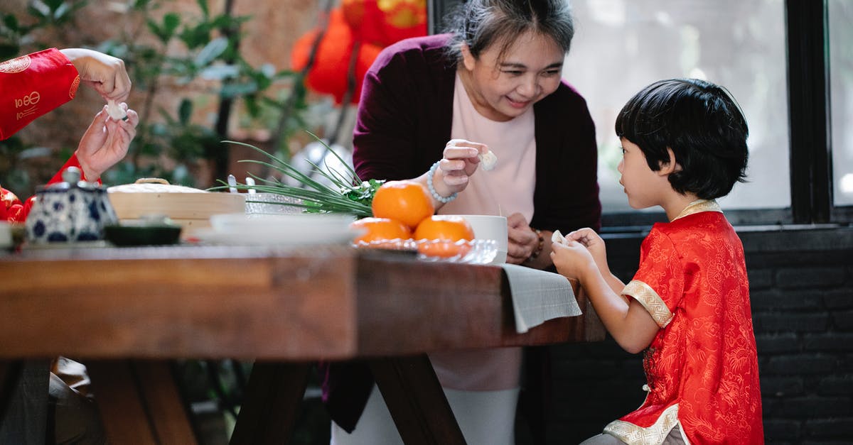 Why fold in ingredients, why not just whisk? - Smiling mature ethnic woman helping little grandson to fold Chinese dumplings Why fold in ingredients, why not just whisk? - Smiling mature ethnic woman helping little grandson to fold Chinese dumplings