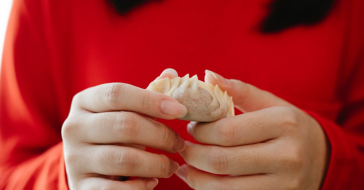 Why fold in ingredients, why not just whisk? - Crop faceless female folding traditional Asian jiaozi dumplings during dinner preparation in kitchen Why fold in ingredients, why not just whisk? - Crop faceless female folding traditional Asian jiaozi dumplings during dinner preparation in kitchen