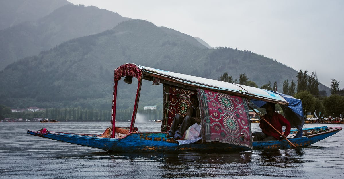 Why fry a teaspoon of dal to start an Indian dish? - Anonymous ethnic men in roofed boat on lake against ridge Why fry a teaspoon of dal to start an Indian dish? - Anonymous ethnic men in roofed boat on lake against ridge