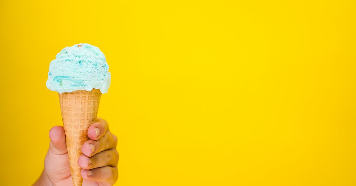 Why is  Ice Cream used in Hot Buttered Rum? - Person Holding White Ice Cream