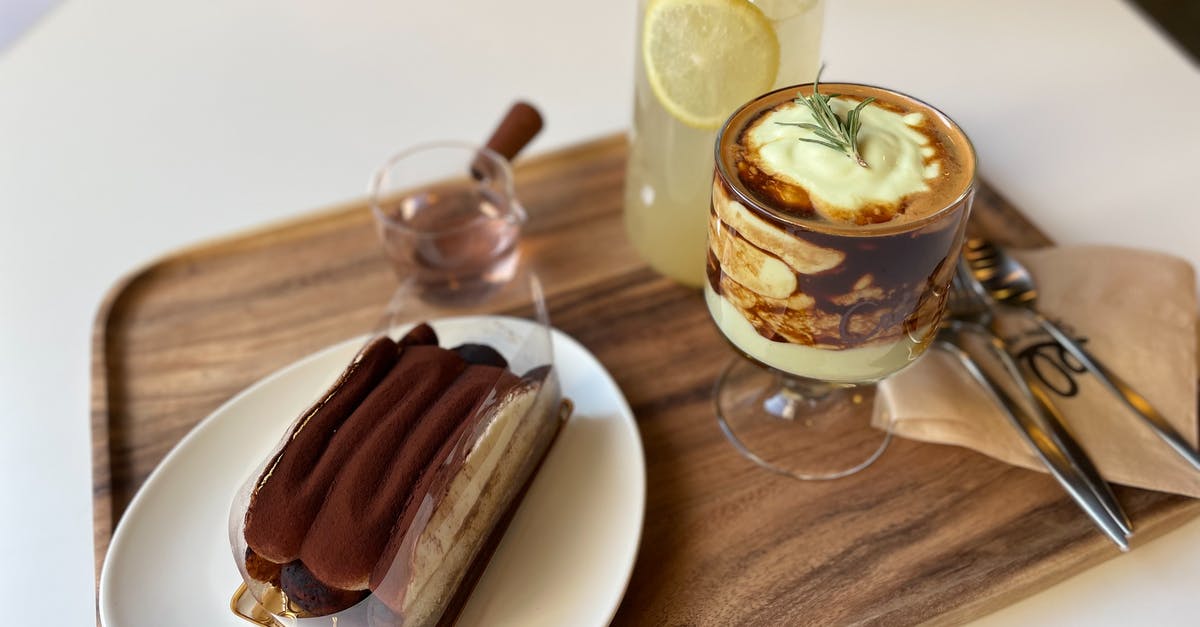 Why is cream curdled in coffee? - Clear Glass Cup With Ice Cream on Brown Wooden Table Why is cream curdled in coffee? - Clear Glass Cup With Ice Cream on Brown Wooden Table