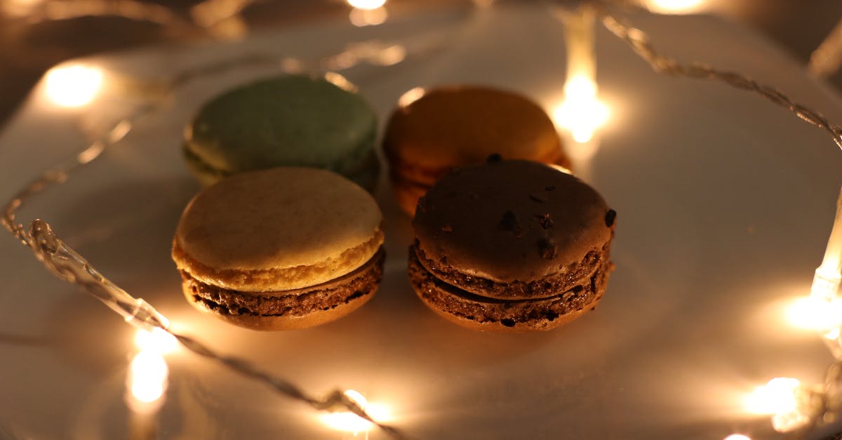 Why is dark chocolate dark when pure cocoa is light brown? - Four Assorted Macaroons on Plate Why is dark chocolate dark when pure cocoa is light brown? - Four Assorted Macaroons on Plate