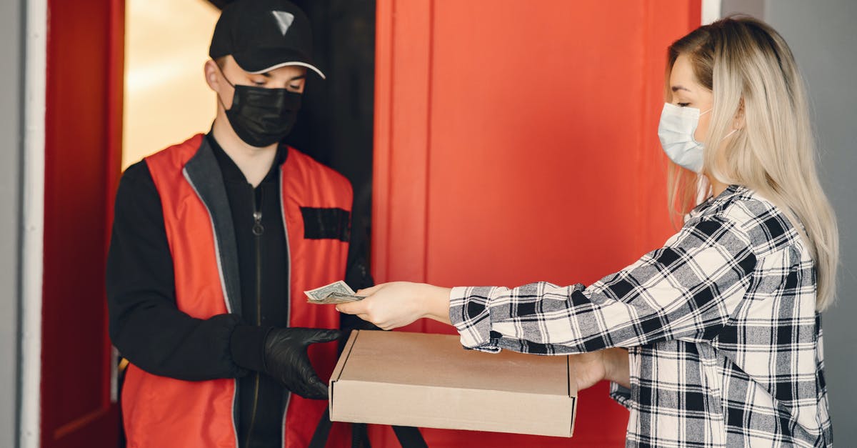 Why is delivered pizza often oily? - Young female customer receiving pizza during coronavirus pandemic quarantine Why is delivered pizza often oily? - Young female customer receiving pizza during coronavirus pandemic quarantine
