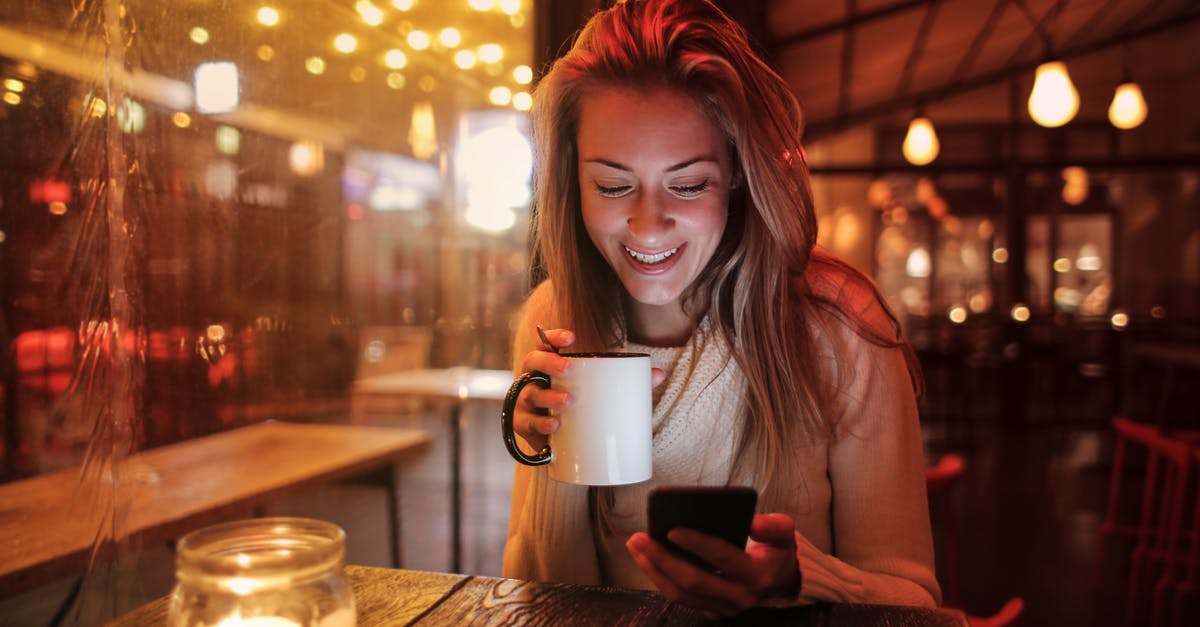 why is exterior of the microwave oven getting hot & the lights getting switched off [closed] - Woman Holding White Ceramic Mug Looking at Her Cellphone