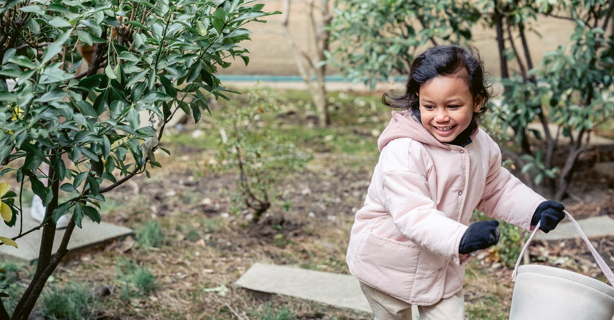 Why is it easier to separate a cold egg? - Smiling ethnic girl with soft bucket running in spring garden Why is it easier to separate a cold egg? - Smiling ethnic girl with soft bucket running in spring garden