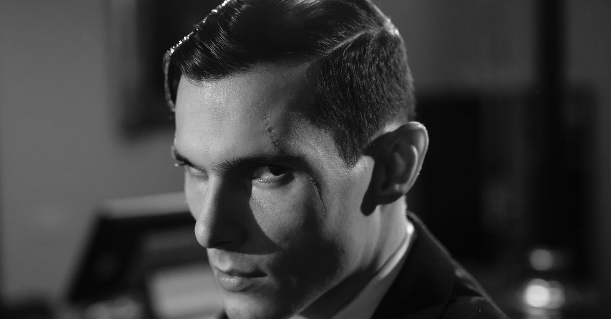 Why is mixing good whiskey with cola/ginger ale frowned upon? [closed] - Close-Up Photo of Serious Man with Scar on his Face