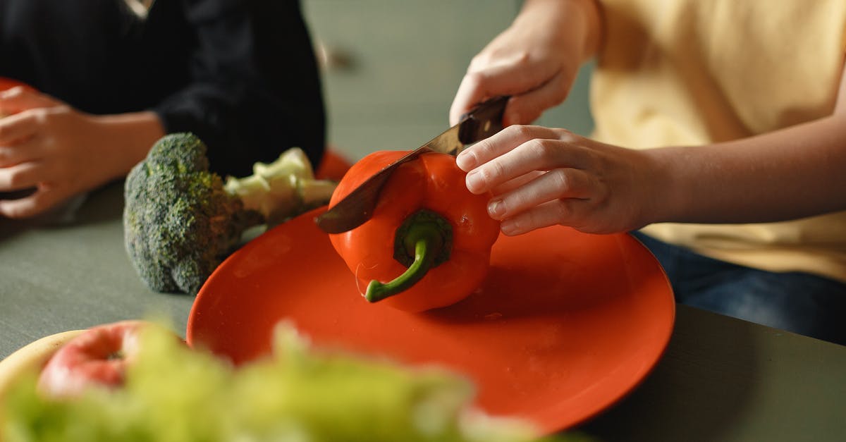 Why is my paste made out of red bell pepper tastes a little astringent? - Unrecognizable boy and girl cutting red pepper on plate sitting at table with various vegetables and fruits while preparing healthy food Why is my paste made out of red bell pepper tastes a little astringent? - Unrecognizable boy and girl cutting red pepper on plate sitting at table with various vegetables and fruits while preparing healthy food