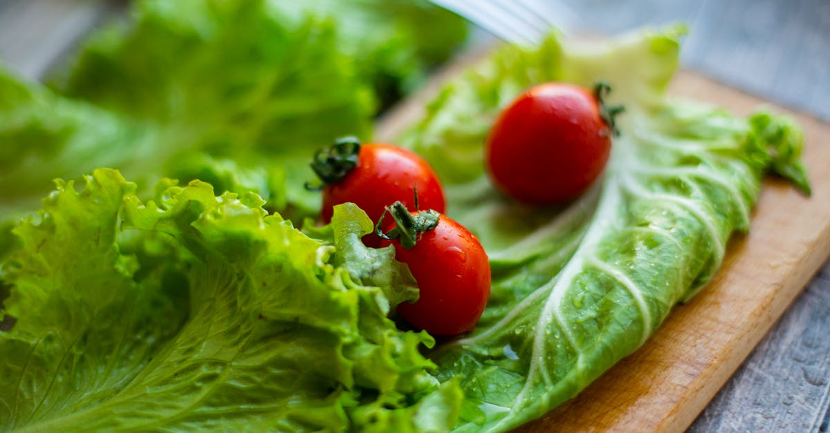 Why is my red cabbage suddenly turning blue when cooking, while it never did so before? - Green salad leaves and ripe tomatoes on wooden cutting board Why is my red cabbage suddenly turning blue when cooking, while it never did so before? - Green salad leaves and ripe tomatoes on wooden cutting board