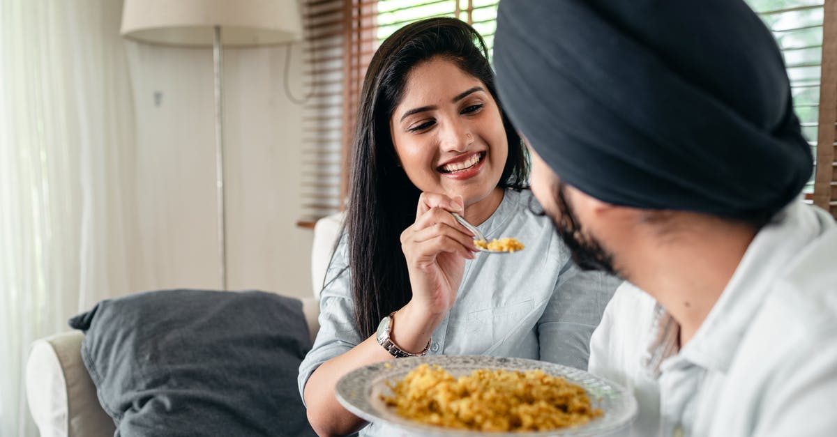 Why is the chicken in Indian food so tender? - Smiling woman feeding man in turban Why is the chicken in Indian food so tender? - Smiling woman feeding man in turban