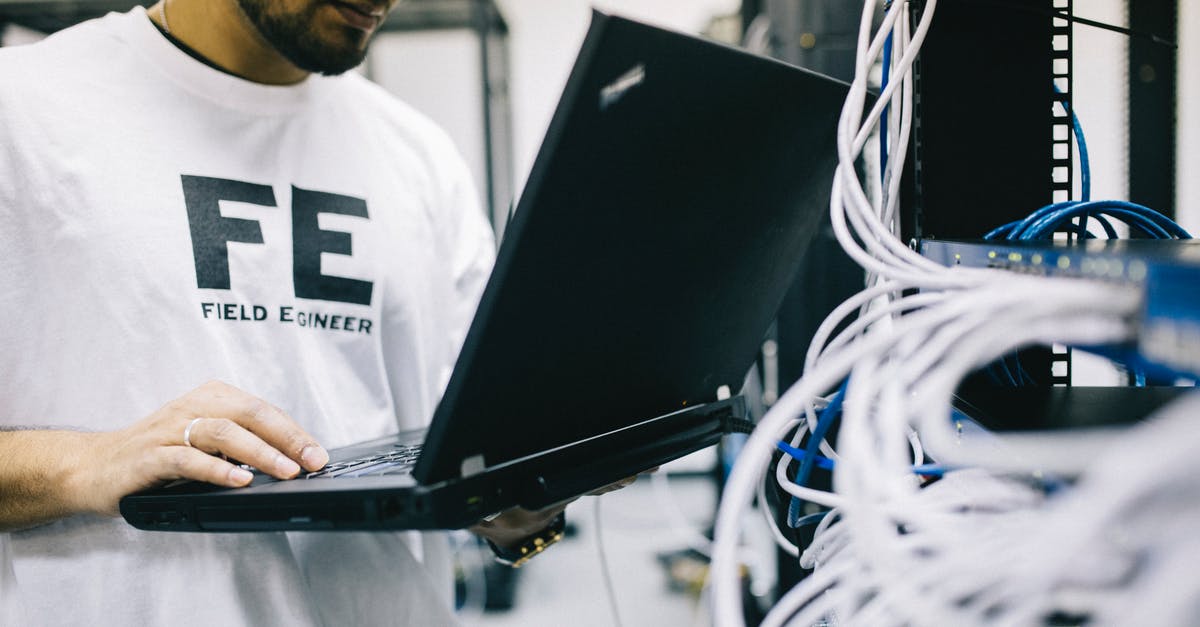 Why is the Gastronorm system based on 530 × 325mm? - Crop focused Asian engineer in white shirt using modern netbook while working with hardware Why is the Gastronorm system based on 530 × 325mm? - Crop focused Asian engineer in white shirt using modern netbook while working with hardware