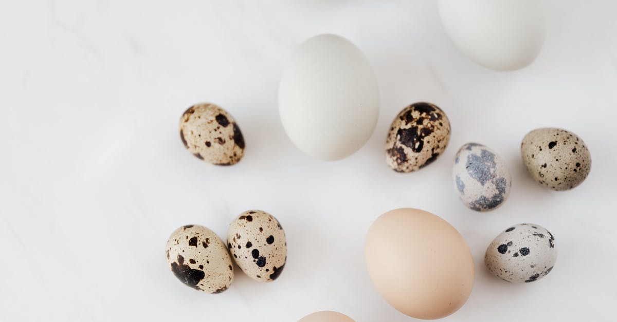 Why isn't it safe to eat raw chicken? - Top view of fragile quail and chicken eggs scattered on marble surface before cooking Why isn't it safe to eat raw chicken? - Top view of fragile quail and chicken eggs scattered on marble surface before cooking