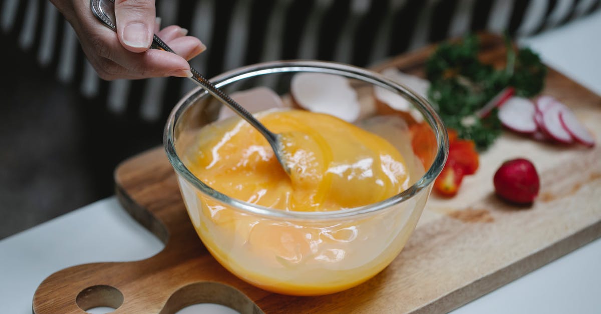 Why or why not beat an egg before adding? - Woman mixing ingredients for breakfast in kitchen Why or why not beat an egg before adding? - Woman mixing ingredients for breakfast in kitchen