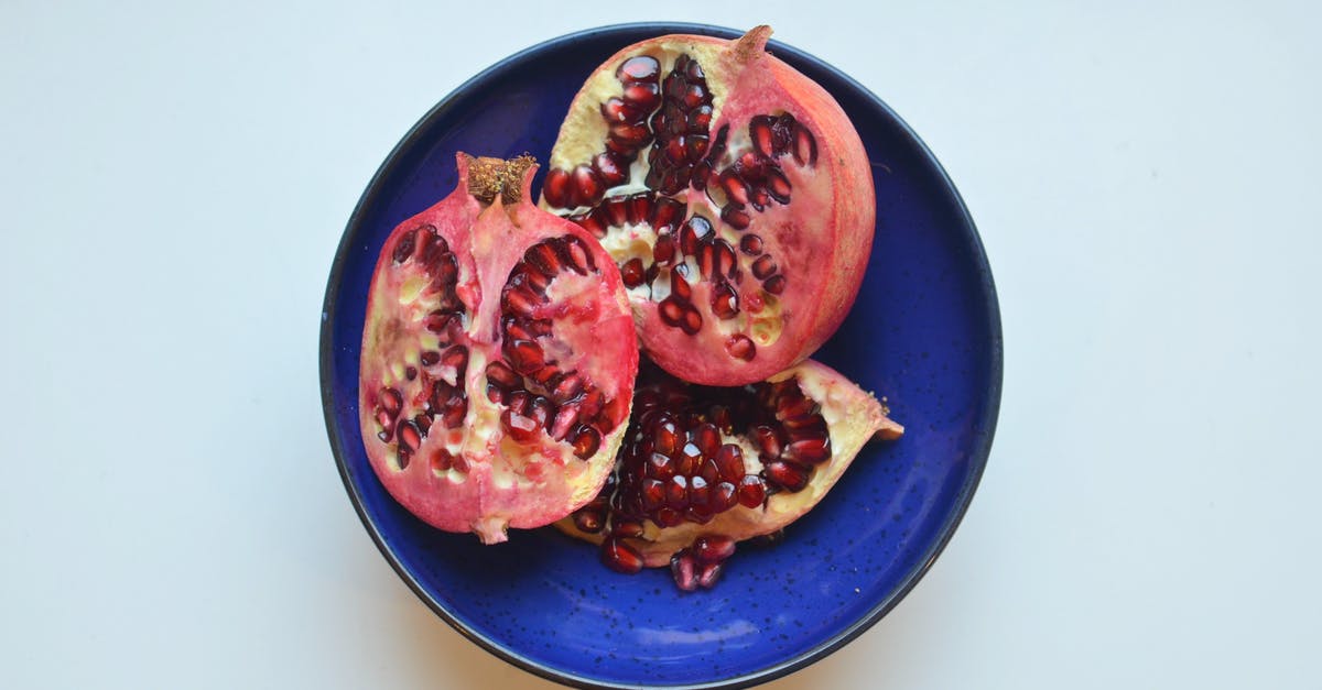 why pepitas (pumpkin seeds) taste like blue cheese? - Top view of fresh ripe halves of pomegranate with red seeds in bowl placed on white background in light kitchen why pepitas (pumpkin seeds) taste like blue cheese? - Top view of fresh ripe halves of pomegranate with red seeds in bowl placed on white background in light kitchen