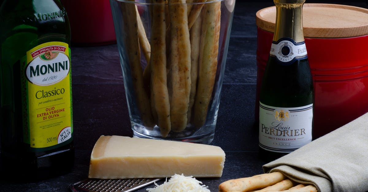 Why to store olive oil in opaque bottles? - Ingredients for cooking including vine cheese and bread sticks Why to store olive oil in opaque bottles? - Ingredients for cooking including vine cheese and bread sticks