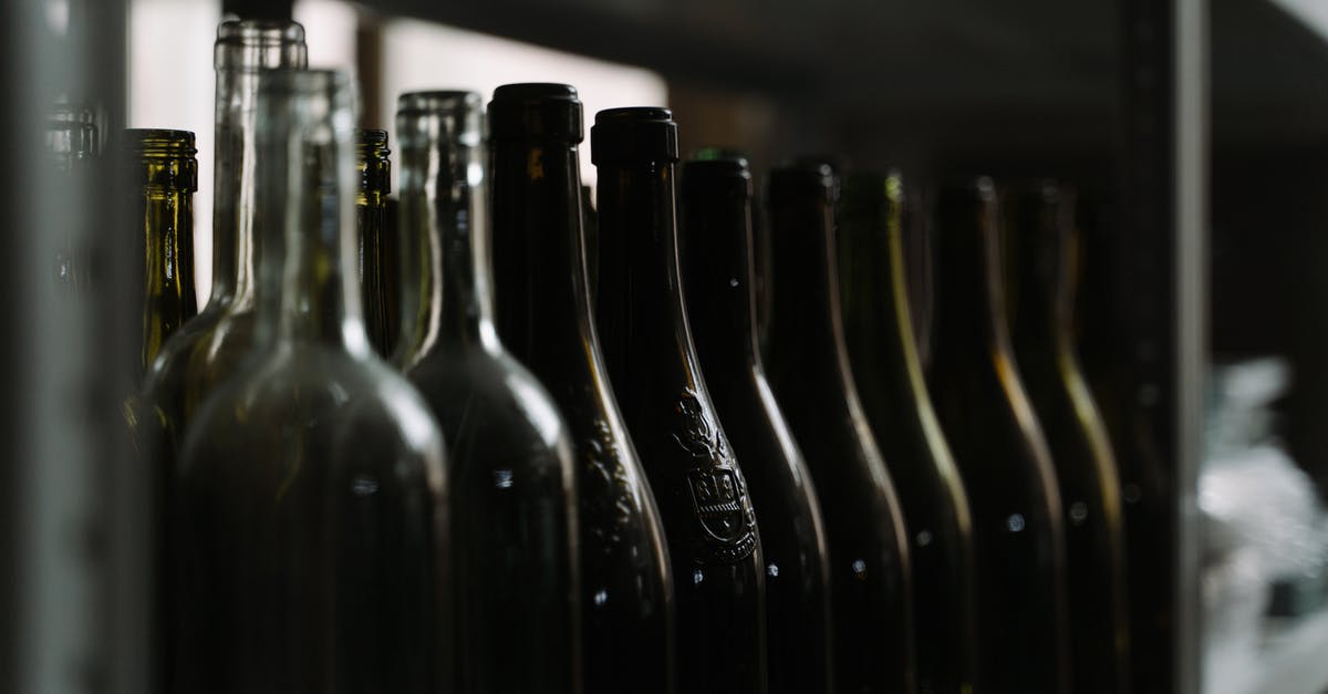 Why wine _before_ butter in shrimp scampi? - Black Glass Bottles on Table Why wine _before_ butter in shrimp scampi? - Black Glass Bottles on Table