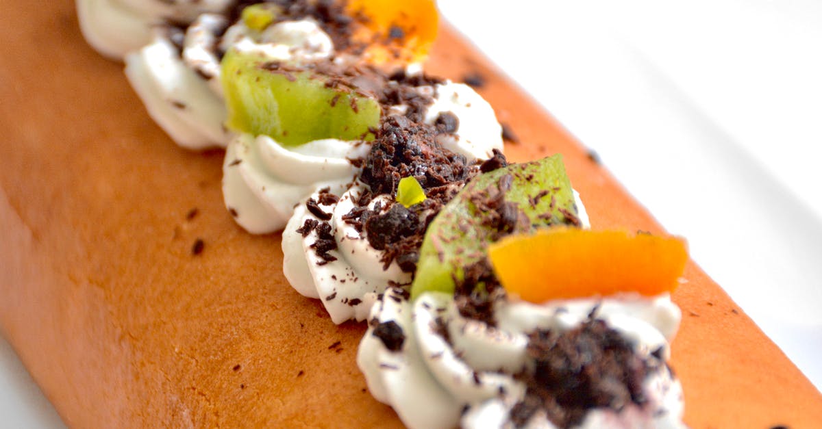 Why won't my whipped cream (with extras) stiffen up? - Closeup of delicious fresh baked Swiss roll topped with chocolate and cut fresh fruits placed o white table in kitchen Why won't my whipped cream (with extras) stiffen up? - Closeup of delicious fresh baked Swiss roll topped with chocolate and cut fresh fruits placed o white table in kitchen