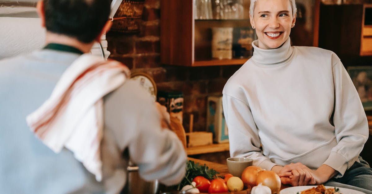 Why would I add garlic to a recipe after onion with such a small time difference? - Man cooking dinner on counter near woman in kitchen Why would I add garlic to a recipe after onion with such a small time difference? - Man cooking dinner on counter near woman in kitchen