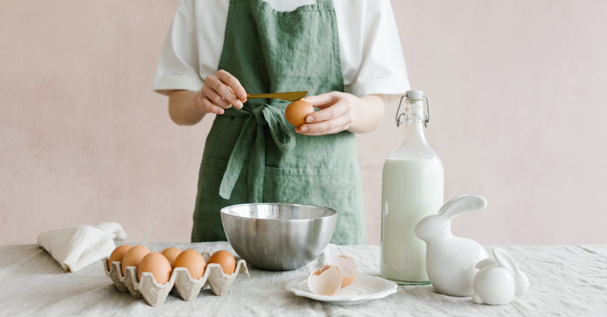 Why would rasagullas break while cooking? - Crop anonymous female with egg in hand at table with iron bowl and glass bottle of milk Why would rasagullas break while cooking? - Crop anonymous female with egg in hand at table with iron bowl and glass bottle of milk