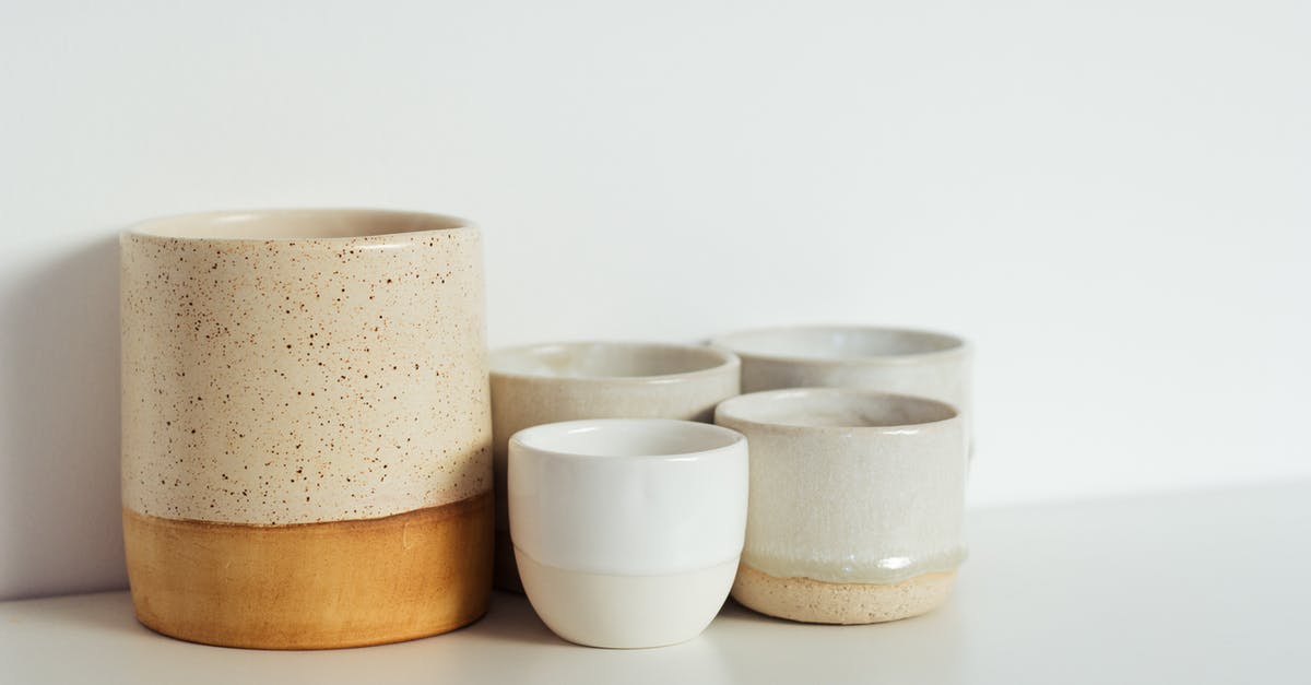 Will changing the setting on my Crock Pot reset the timer? - Collection of white and beige ceramic cups placed on shelf in light kitchen Will changing the setting on my Crock Pot reset the timer? - Collection of white and beige ceramic cups placed on shelf in light kitchen