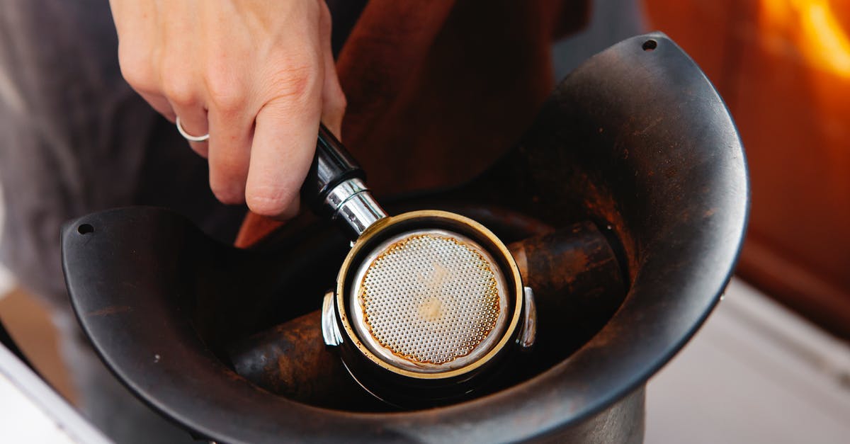 Will dry ice damage kitchen equipment? - From above of faceless female employee with metal portafilter in electric coffee grinder in cafe Will dry ice damage kitchen equipment? - From above of faceless female employee with metal portafilter in electric coffee grinder in cafe