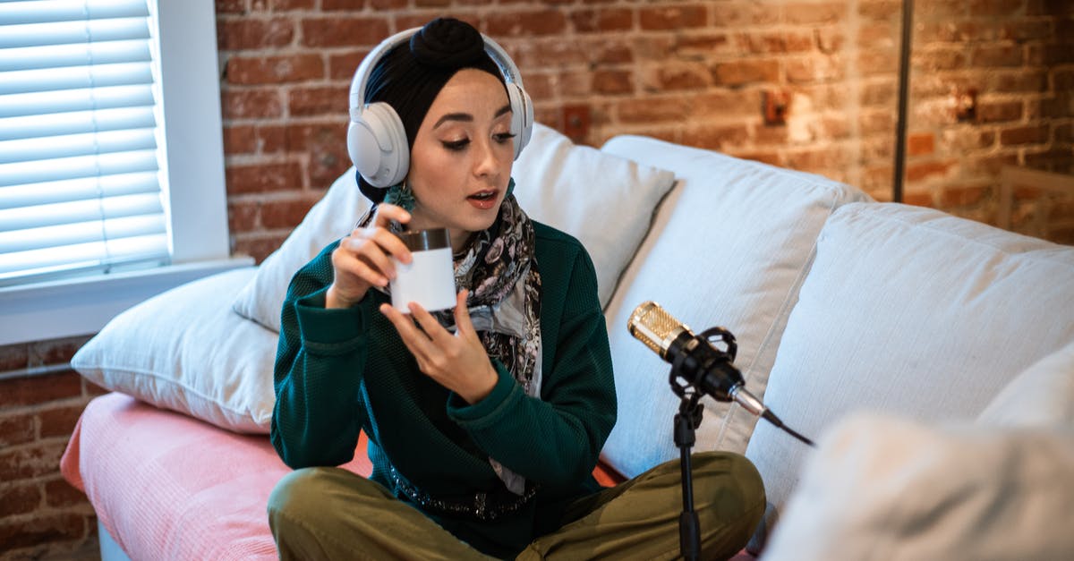 Would this be called matured cream? - Woman in Green Long Sleeve Shirt and Green Pants Sitting on Sofa Holding a Beauty Product Would this be called matured cream? - Woman in Green Long Sleeve Shirt and Green Pants Sitting on Sofa Holding a Beauty Product