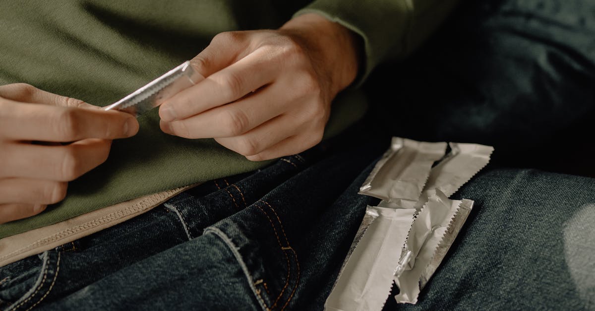 Xanthan Gum in sauce/gravy - Person in Blue Denim Jeans Holding White Plastic Pack Xanthan Gum in sauce/gravy - Person in Blue Denim Jeans Holding White Plastic Pack